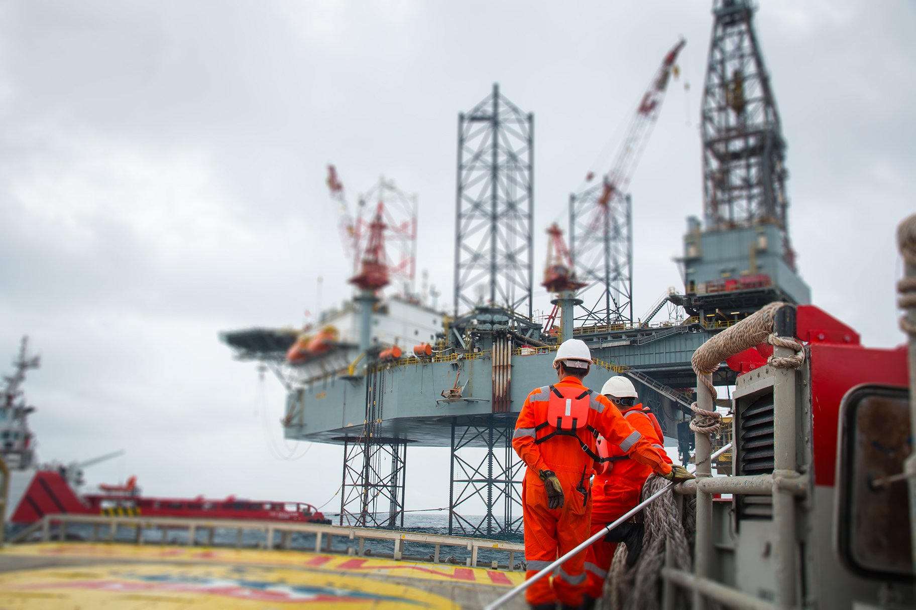 Technicians checking the pneumatic control valve on an offshore oil rig
