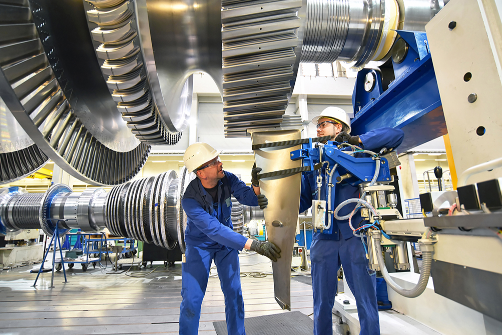 Mechanical engineering technicians assemble a gas turbine for the power industry